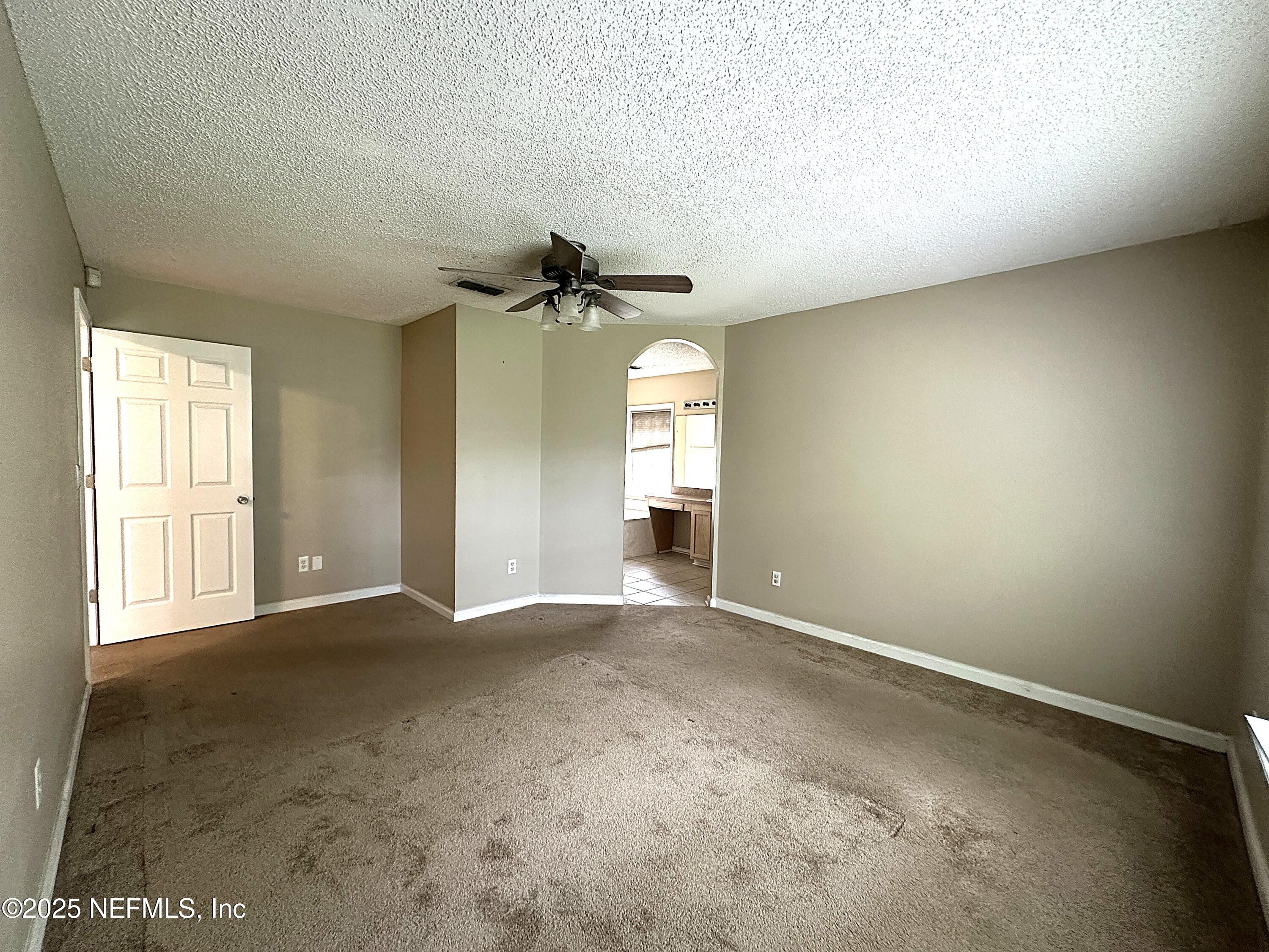 83041 St Mark Drive Yulee, FL 32097 - Photo 10 of 28 an empty room with a empty space and windows