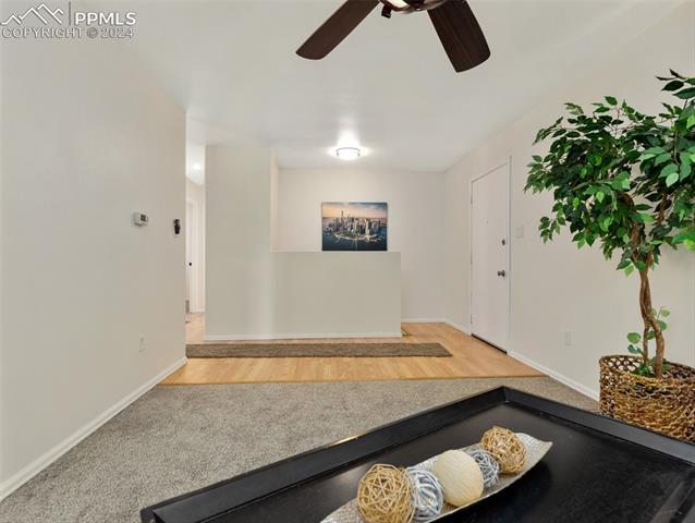 142 Mac Neil Road Pueblo, CO 81001 - Photo 9 of 24 Carpeted living room featuring ceiling fan