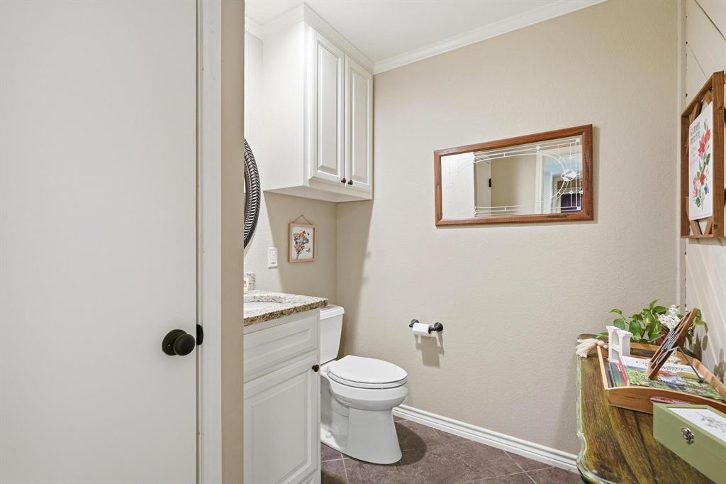 432 Clark Road Abilene, TX 79602 - Photo 18 of 40 a bathroom with a toilet a sink and mirror