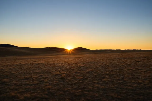 a view of an ocean with a mountain in the background