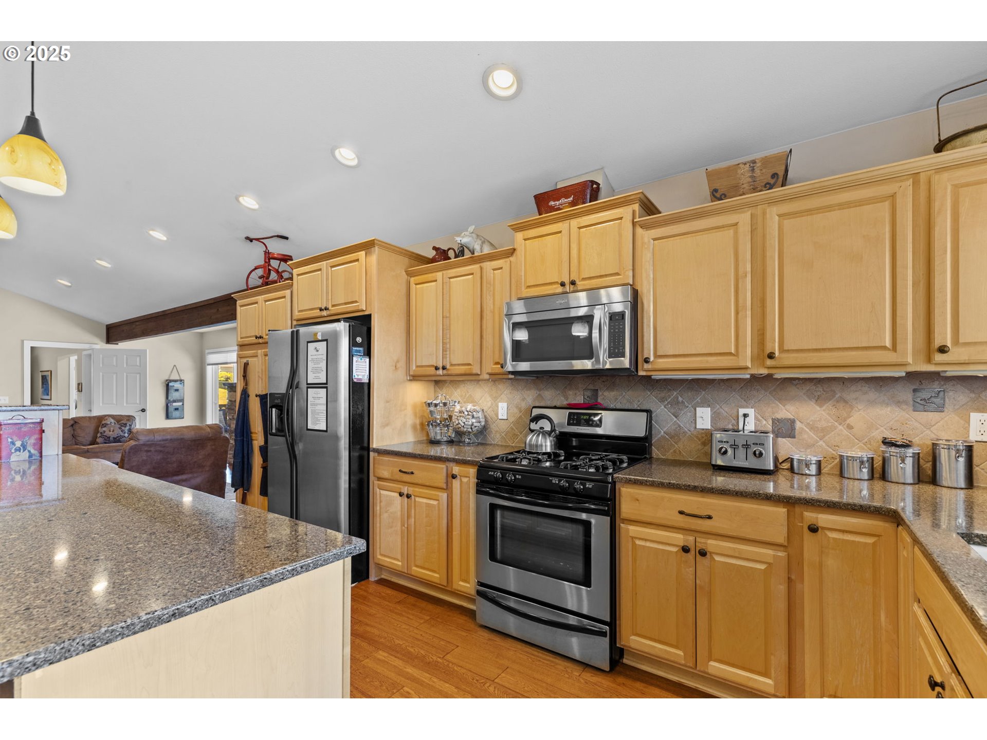 238 Southwest 27th Street Newport, OR 97366 - Photo 7 of 34 a kitchen with stainless steel appliances granite countertop a sink a stove and cabinets