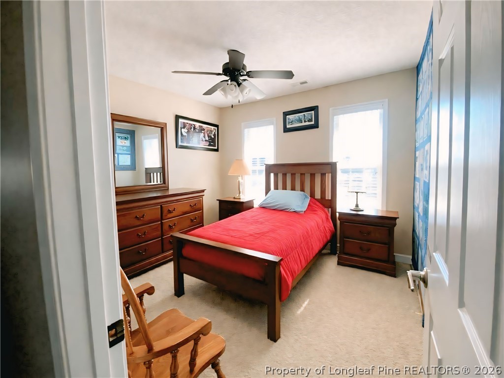 5236 Spreading Branch Road Hope Mills, NC 28348 - Photo 11 of 14 a bedroom with a bed and furniture