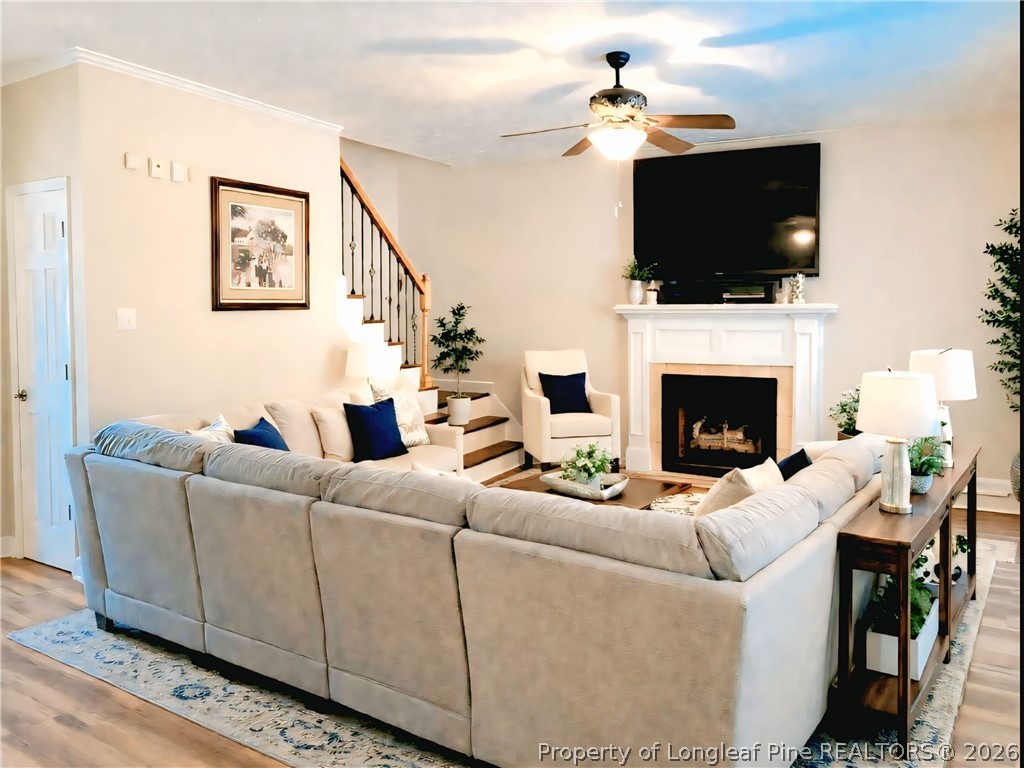 5236 Spreading Branch Road Hope Mills, NC 28348 - Photo 2 of 14 a living room with furniture a fireplace and a flat screen tv
