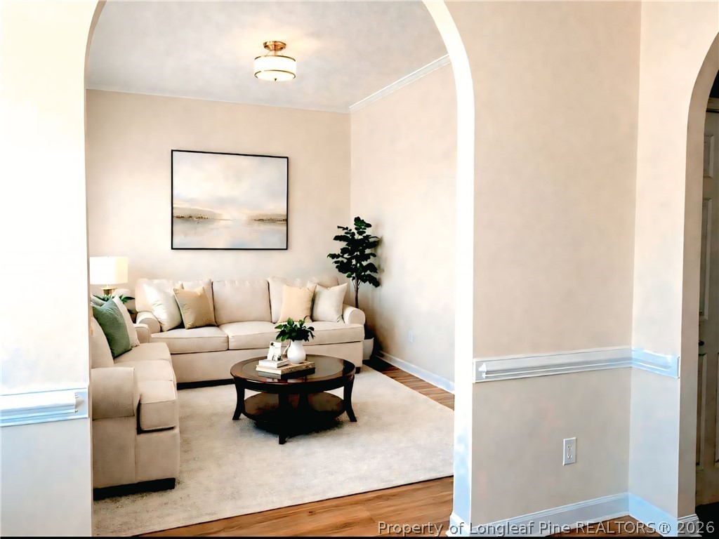 5236 Spreading Branch Road Hope Mills, NC 28348 - Photo 3 of 14 a living room with furniture and a painting on the wall