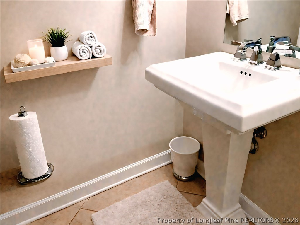 5236 Spreading Branch Road Hope Mills, NC 28348 - Photo 5 of 14 a bathroom with a sink toilet and a mirror
