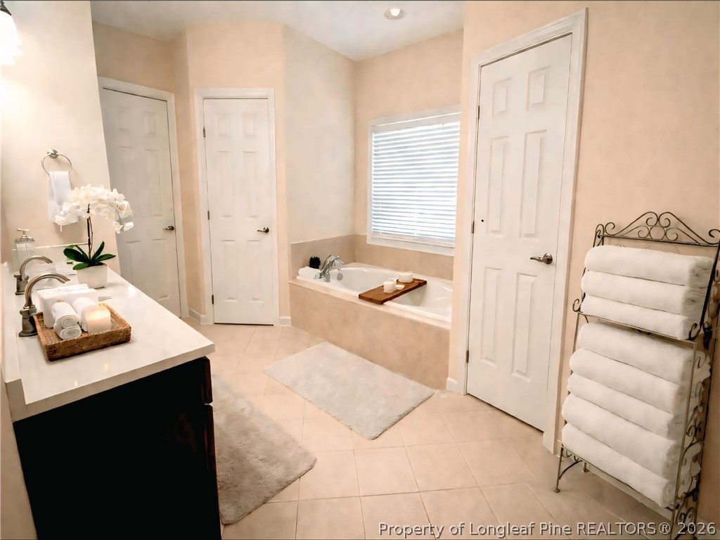 5236 Spreading Branch Road Hope Mills, NC 28348 - Photo 8 of 14 a bedroom with a bed and a cabinets