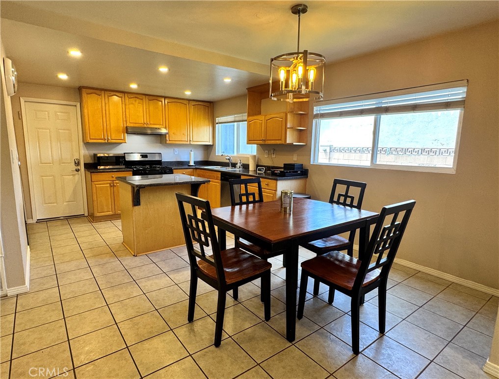 2065 Morley Street Simi Valley, CA 93065 - Photo 3 of 13 a view of a dining room with furniture and a chandelier