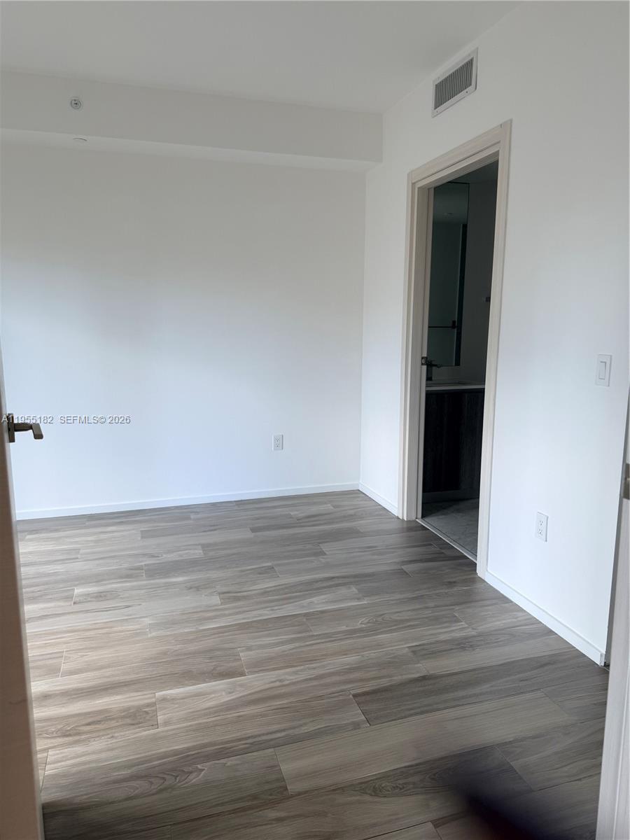 801 South Miami Avenue, Unit 2002 Miami, FL 33131 - Photo 16 of 19 a view of an empty room and wooden floor