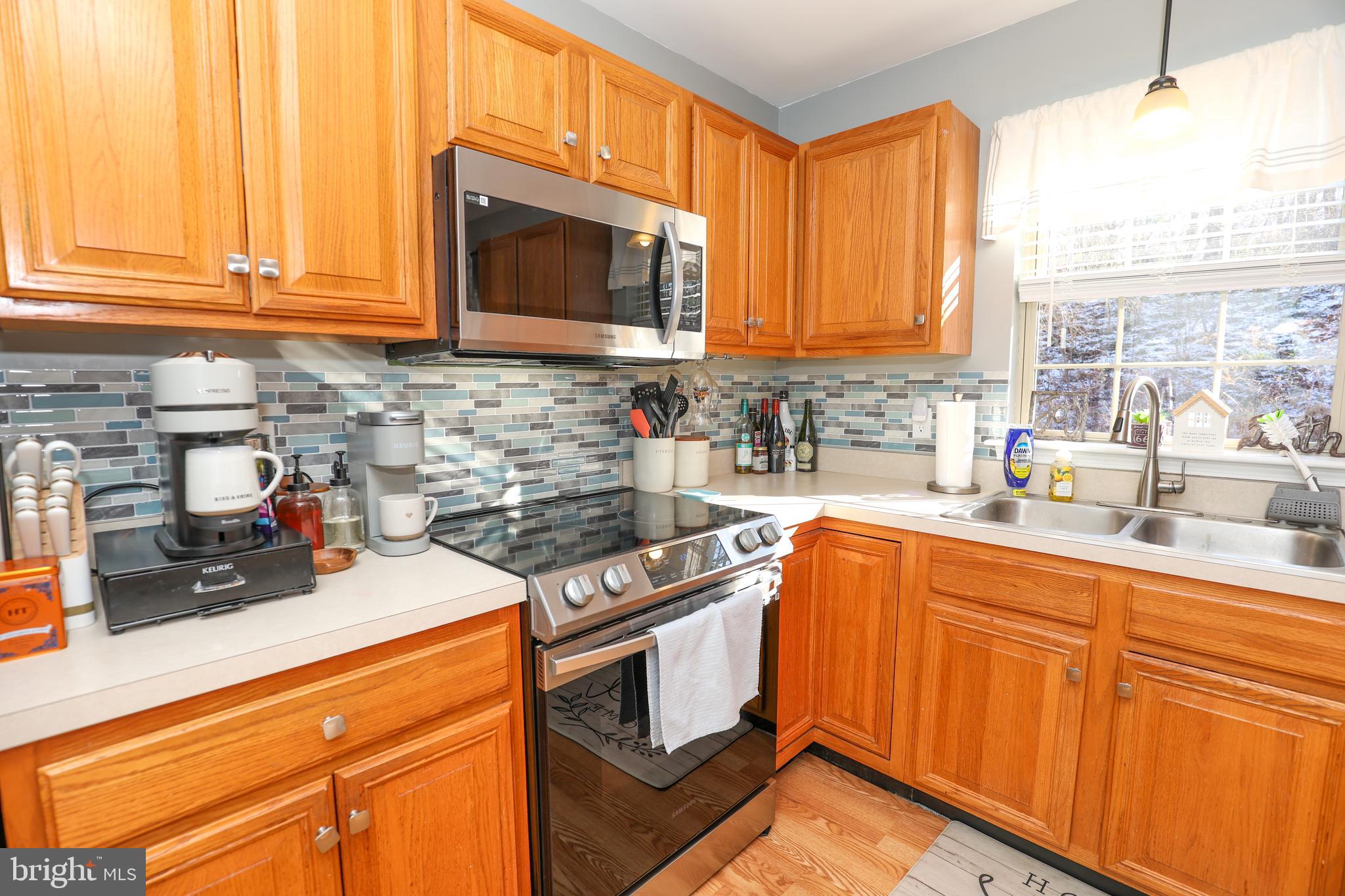 407 Crosswinds Drive Lititz, PA 17543 - Photo 4 of 18 a kitchen with stainless steel appliances granite countertop a sink a stove cabinets and a microwave oven