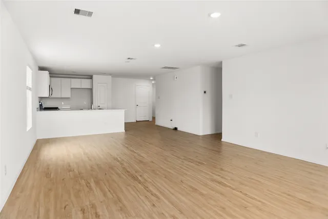a view of a kitchen with wooden floor and a sink