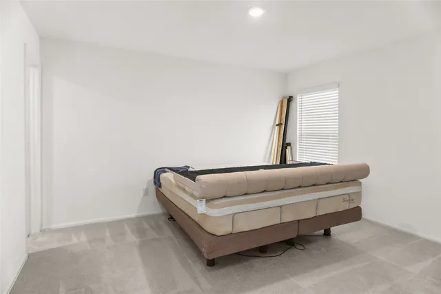 a bedroom with furniture and a window