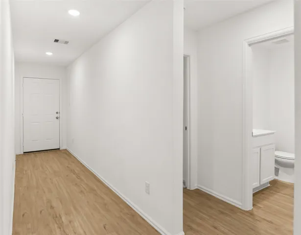 a view of hallway with wooden floor