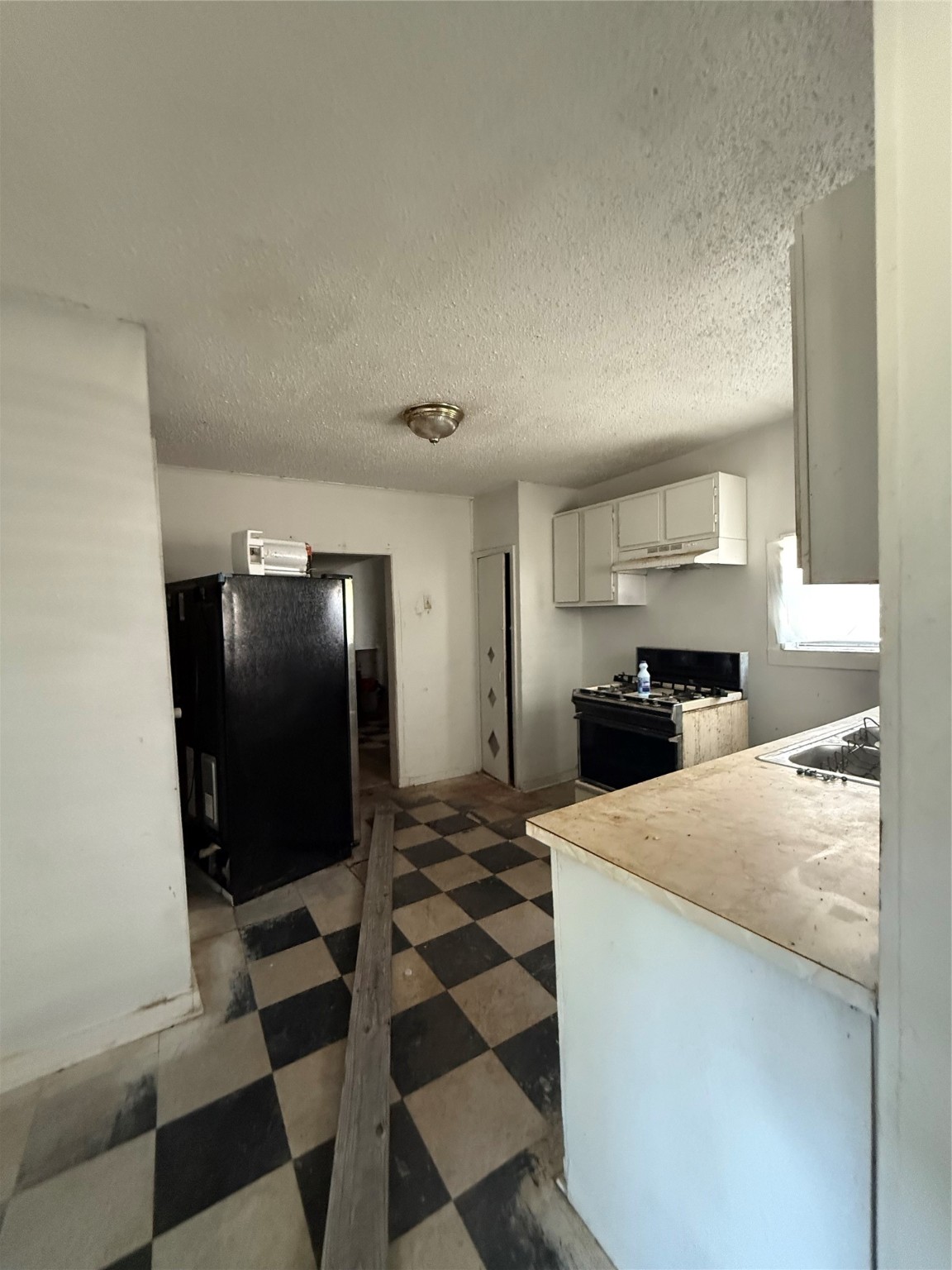 2478 Druid Street Houston, TX 77091 - Photo 29 of 29 a kitchen with a refrigerator and a sink