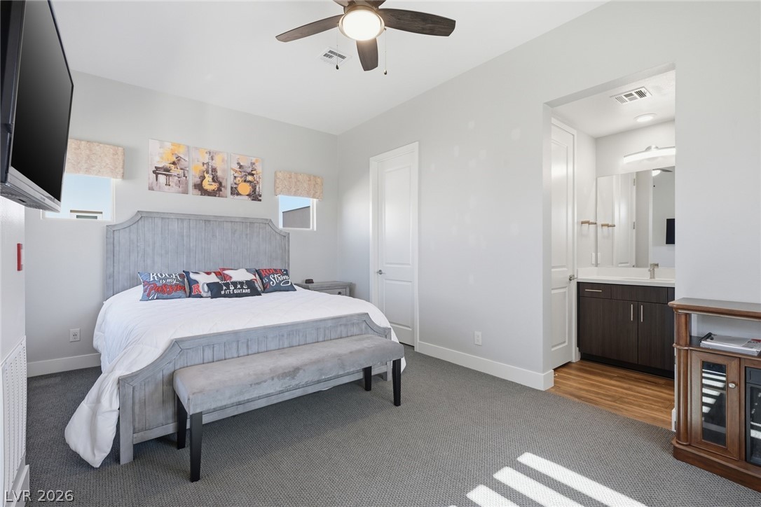 4246 Swift Street Las Vegas, NV 89135 - Photo 33 of 71 Bedroom featuring light colored carpet, a ceiling fan, and connected bathroom