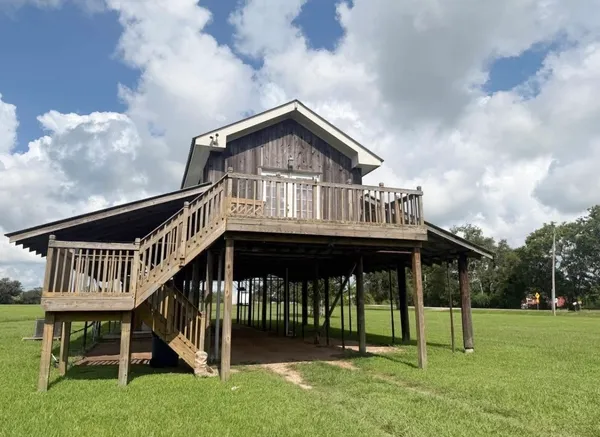 a view of house with yard and entertaining space