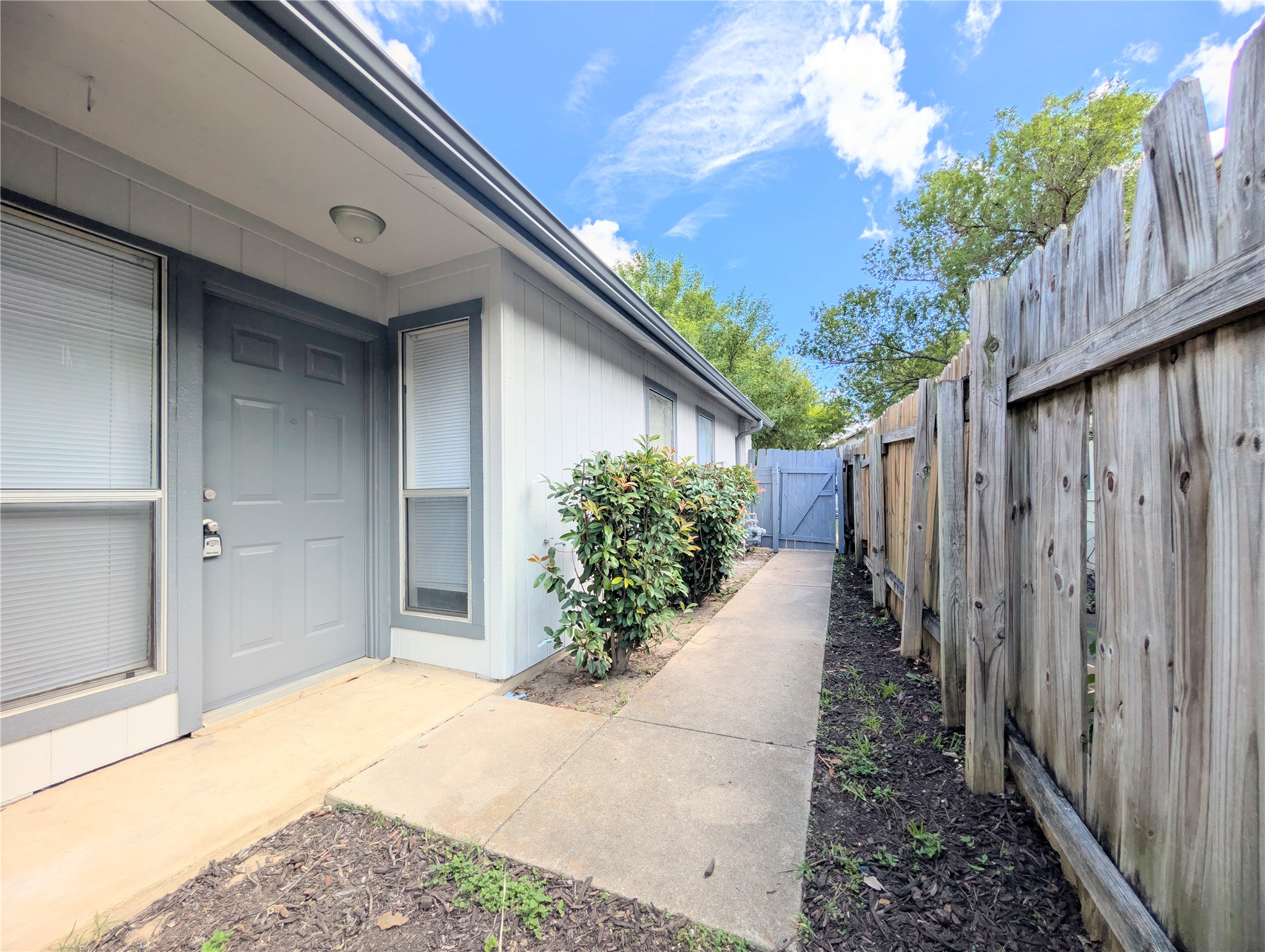 2036 Redwing Way Round Rock, TX 78664 - Photo 5 of 23 New coat of paint trim and door. Secure entry via a fenced pathway leads to this private residence.