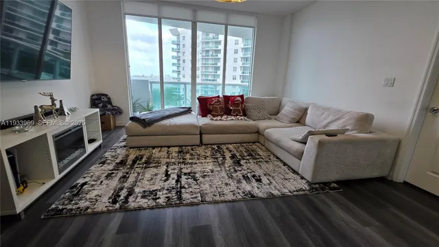a living room with furniture and flowers