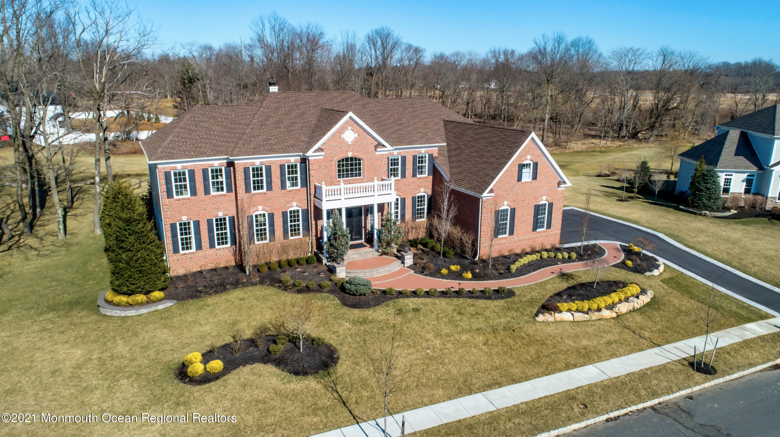 8 Strathmore Road Lincroft, NJ 07738 - Photo 2 of 76 a view of a white house with a yard and lawn chairs
