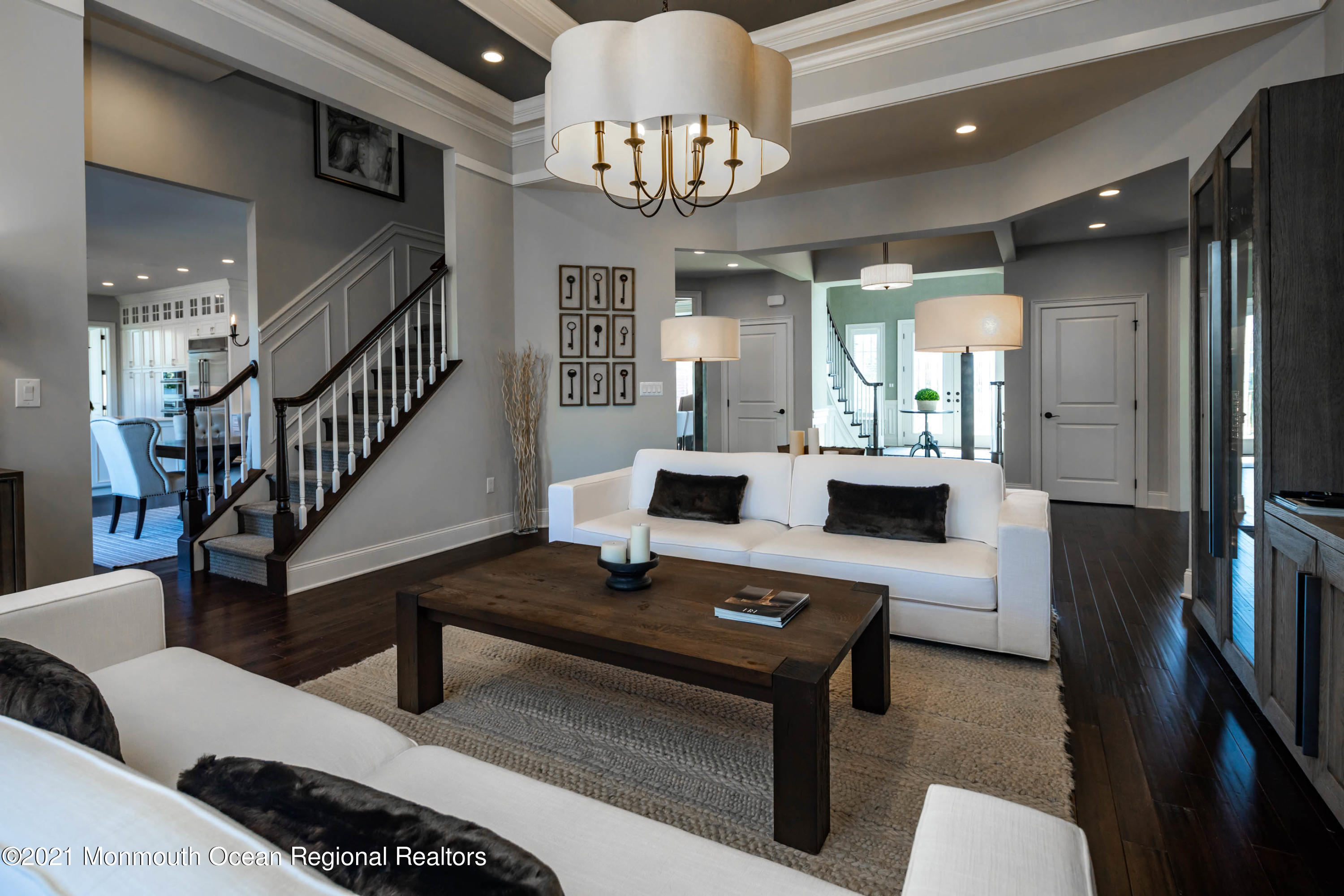8 Strathmore Road Lincroft, NJ 07738 - Photo 24 of 76 a living room with furniture and a chandelier