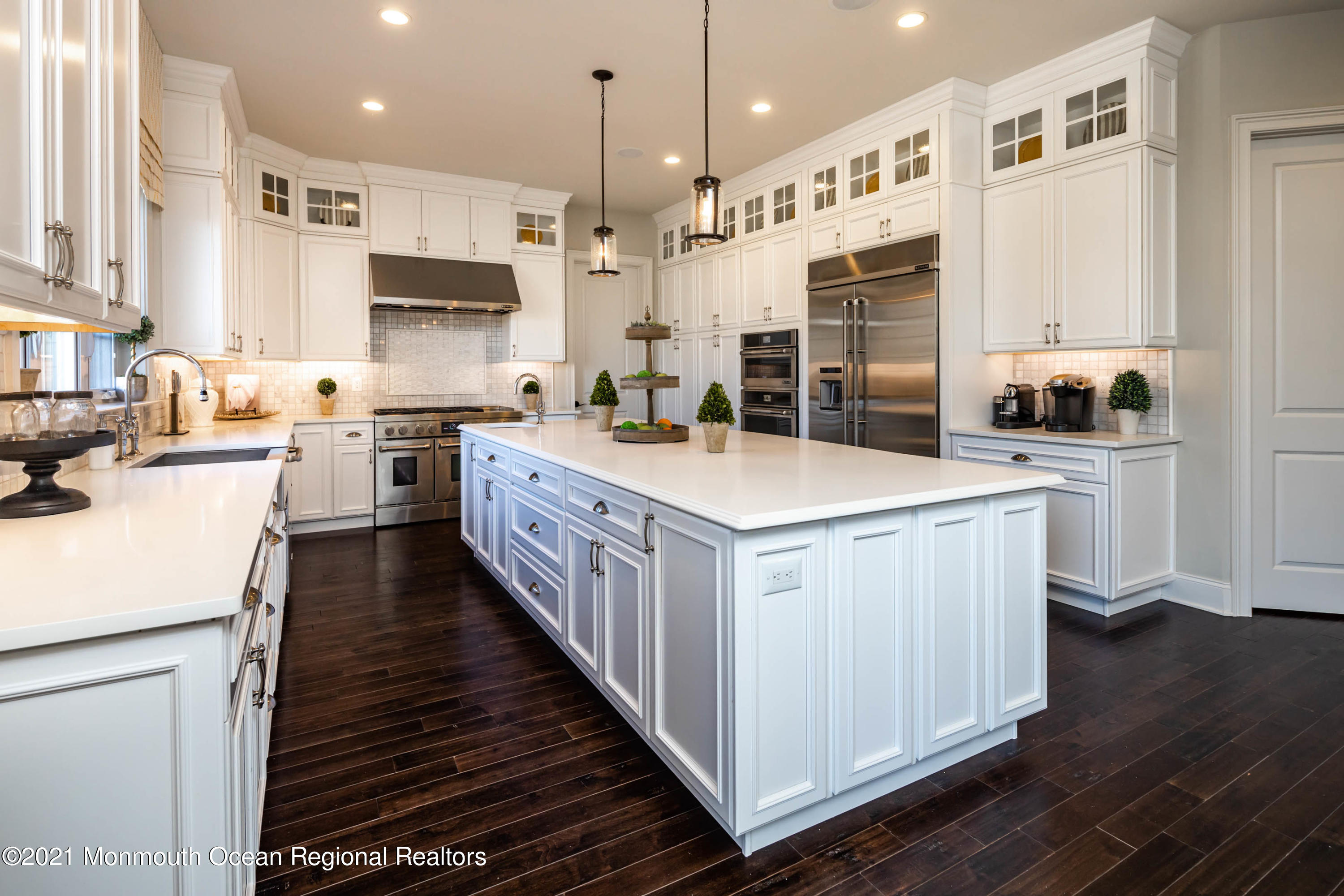 8 Strathmore Road Lincroft, NJ 07738 - Photo 29 of 76 a kitchen with stainless steel appliances a stove top oven a sink a refrigerator white cabinets and wooden floor