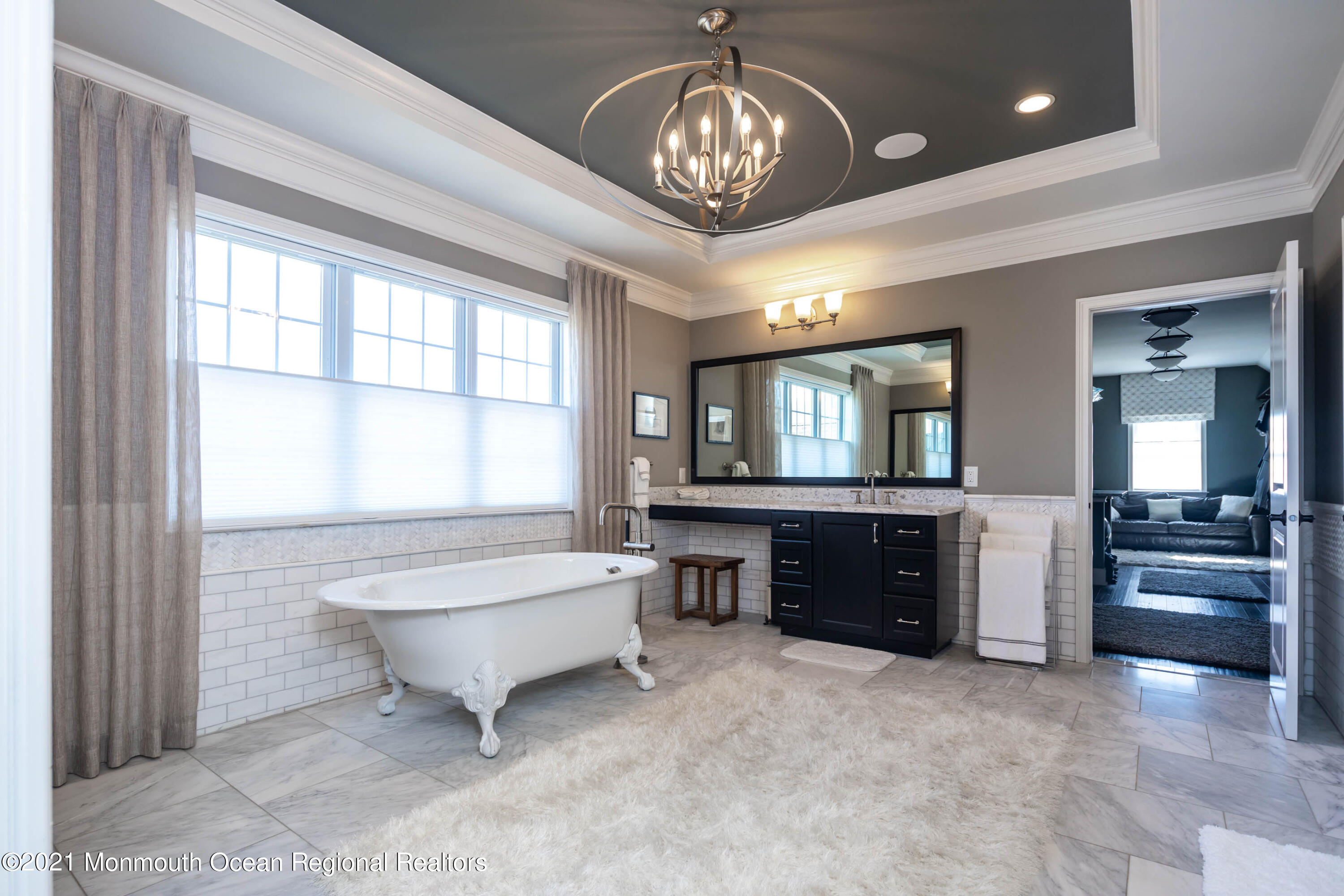 8 Strathmore Road Lincroft, NJ 07738 - Photo 48 of 76 a spacious bedroom with a bed and a chandelier