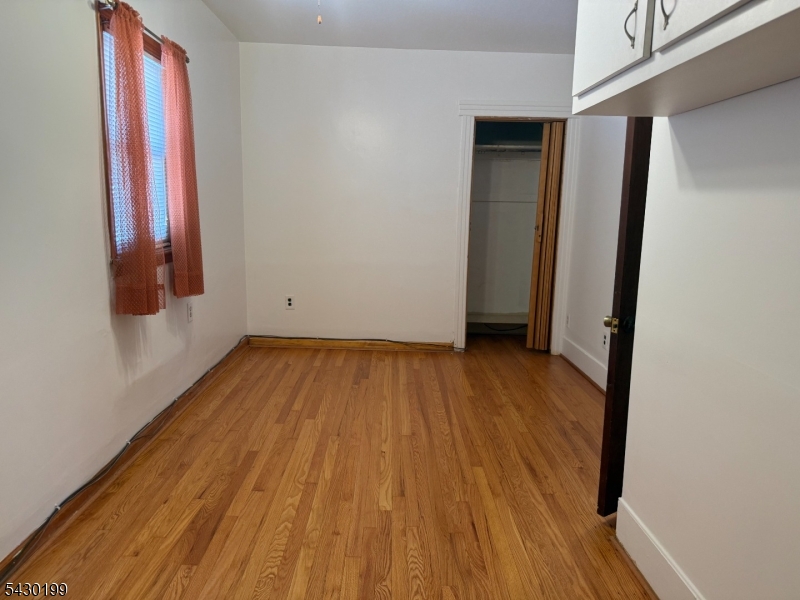 72 Baldwin Place, Unit 2 Bloomfield, NJ 07003 - Photo 18 of 24 a view of a room with wooden floor and doors
