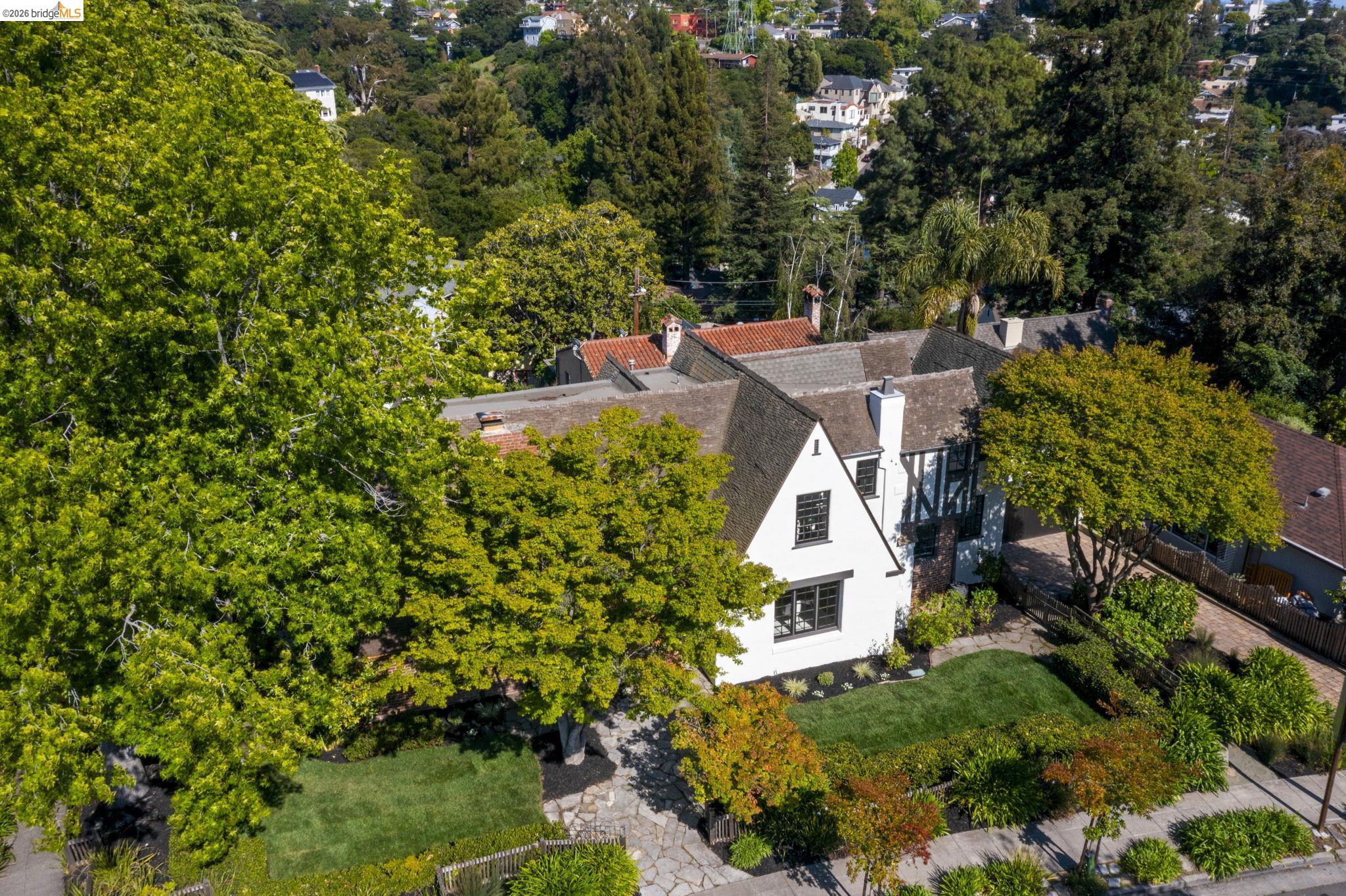 1087 Hubert Road Oakland, CA 94610 - Photo 65 of 67 Tudor-style residence featuring a white facade with dark trim, a gabled roofline, and a prominent chimney