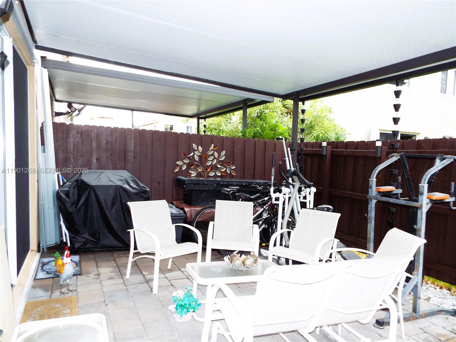 2363 Southeast 11th Street Homestead, FL 33035 - Photo 54 of 68 a view of outdoor dining space with a table and chairs