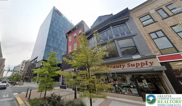 a city street lined with buildings and trees