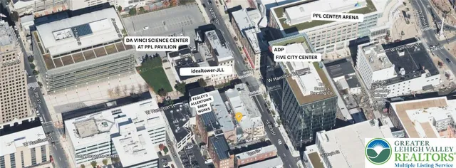 a front view of multi story residential apartment building with yard