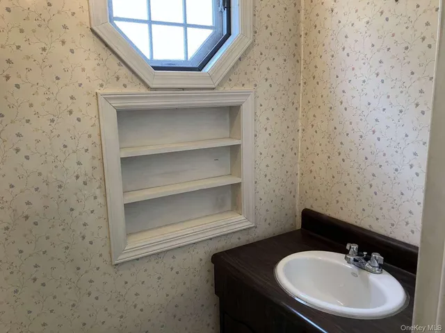 a bathroom with a sink and a mirror