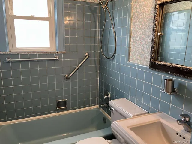 a bathroom with a toilet a sink and bathtub