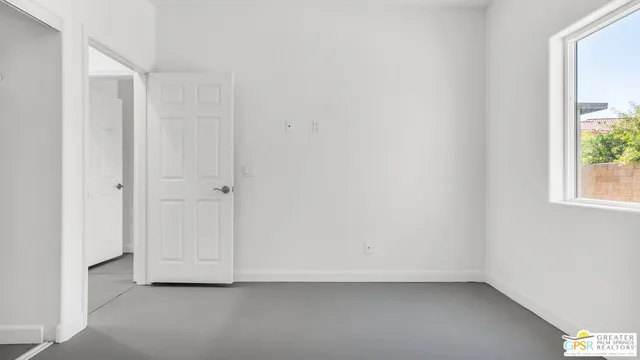 a view of a kitchen with refrigerator and window