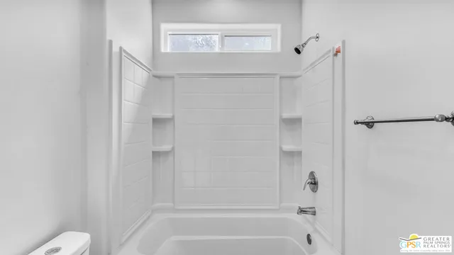a view of a kitchen with a sink and cabinets
