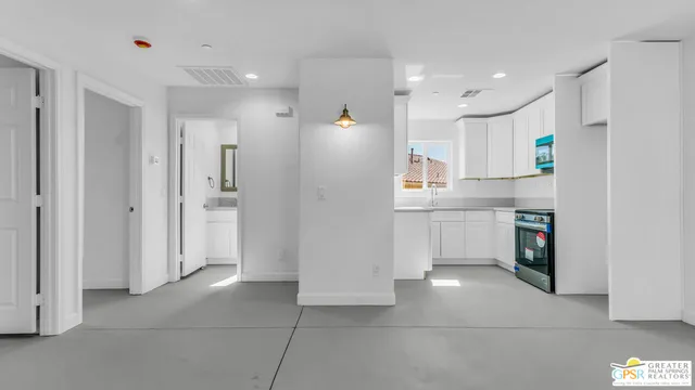a kitchen with a sink cabinets and a window