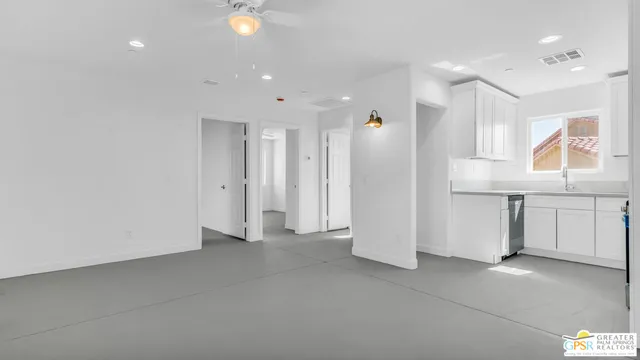 an empty room with windows and closet