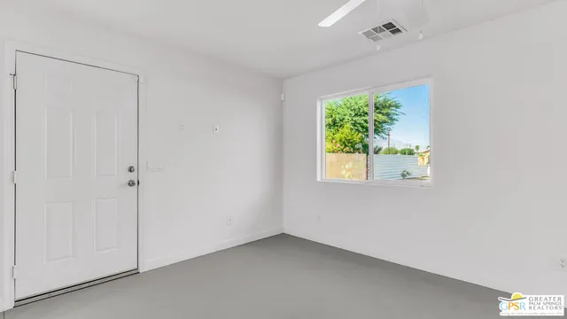 a bathroom with a granite countertop toilet sink and mirror