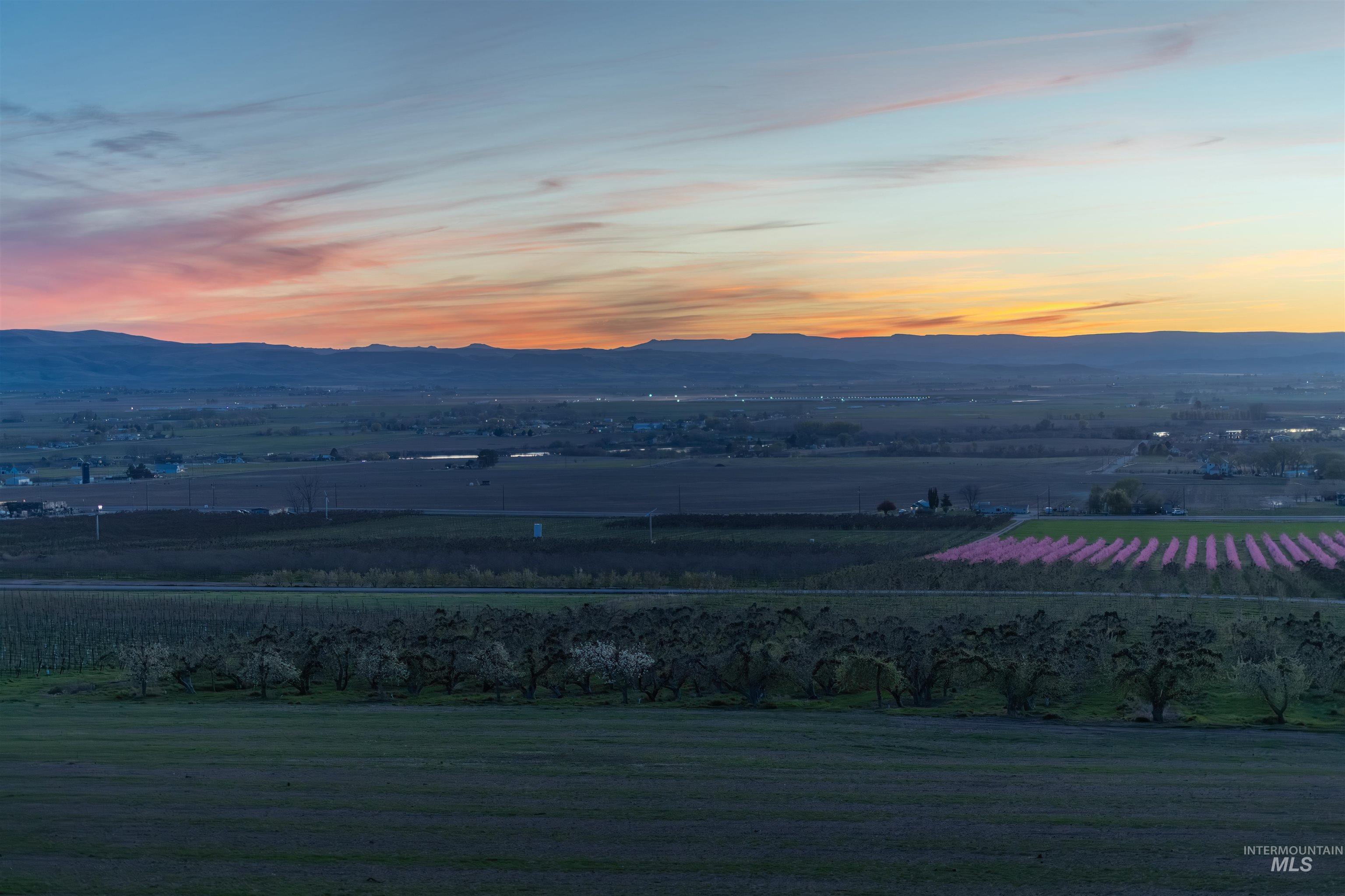 14526 Perfection Lane Caldwell, ID 83607 - Photo 24 of 24 Expansive rural landscape featuring distant mountains and a vibrant sunset