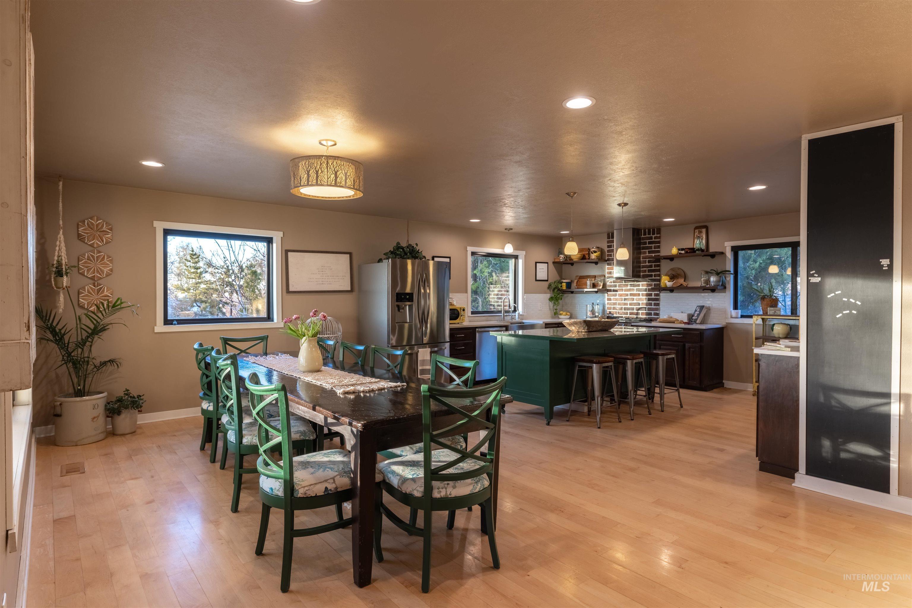 14526 Perfection Lane Caldwell, ID 83607 - Photo 6 of 24 Open-concept living space featuring wood-finish flooring and recessed lighting throughout