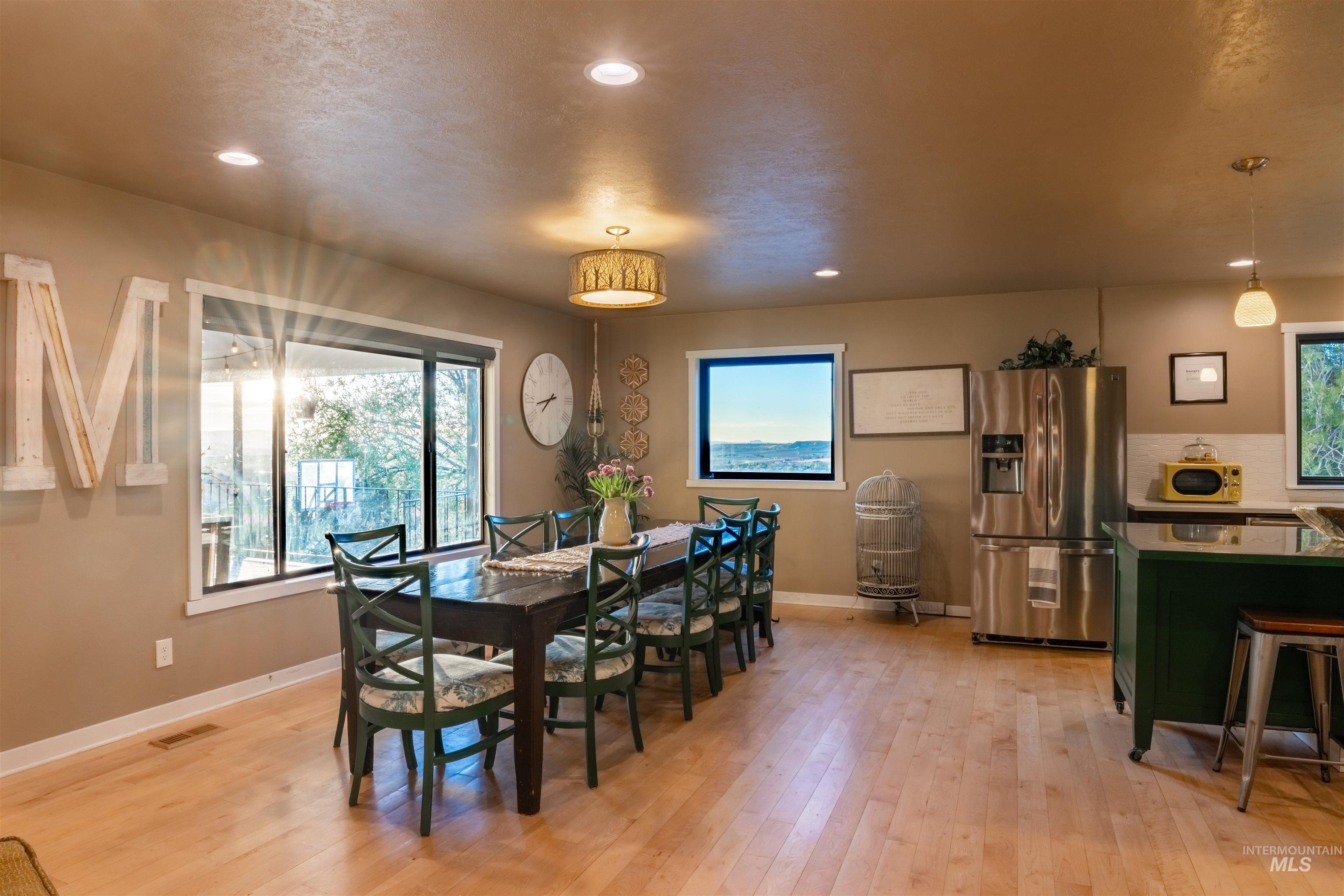 14526 Perfection Lane Caldwell, ID 83607 - Photo 7 of 24 Dining area featuring wood-finish flooring, recessed lighting, and a drum-style ceiling fixture