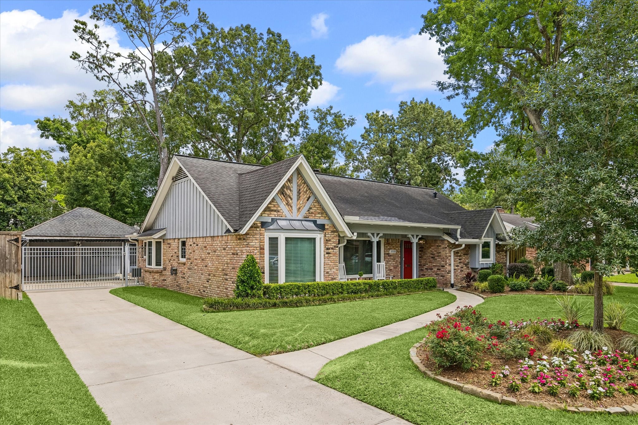 1018 Ben Hur Drive Spring Valley Village, TX 77055 - Photo 28 of 30 An oversized 2-car garage, a grandfathered carport, and an automatic driveway gate enhance the home’s functionality.