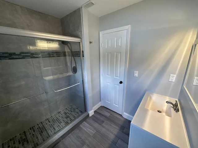 a bathroom with a toilet and a shower