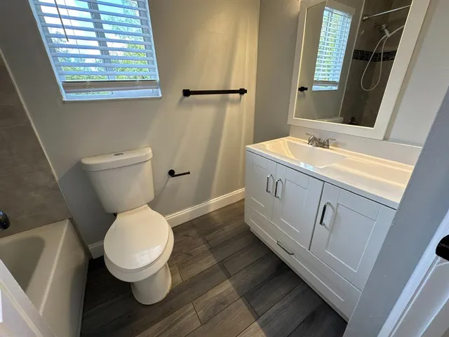 a view of an empty room with a window and a fan