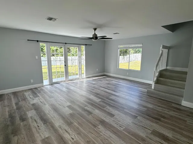 a view of entryway and hall with wooden floor