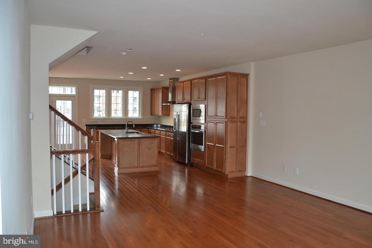 3174 Yeager Drive Herndon, VA 20171 - Photo 8 of 20 a kitchen with stainless steel appliances a refrigerator and wooden floor