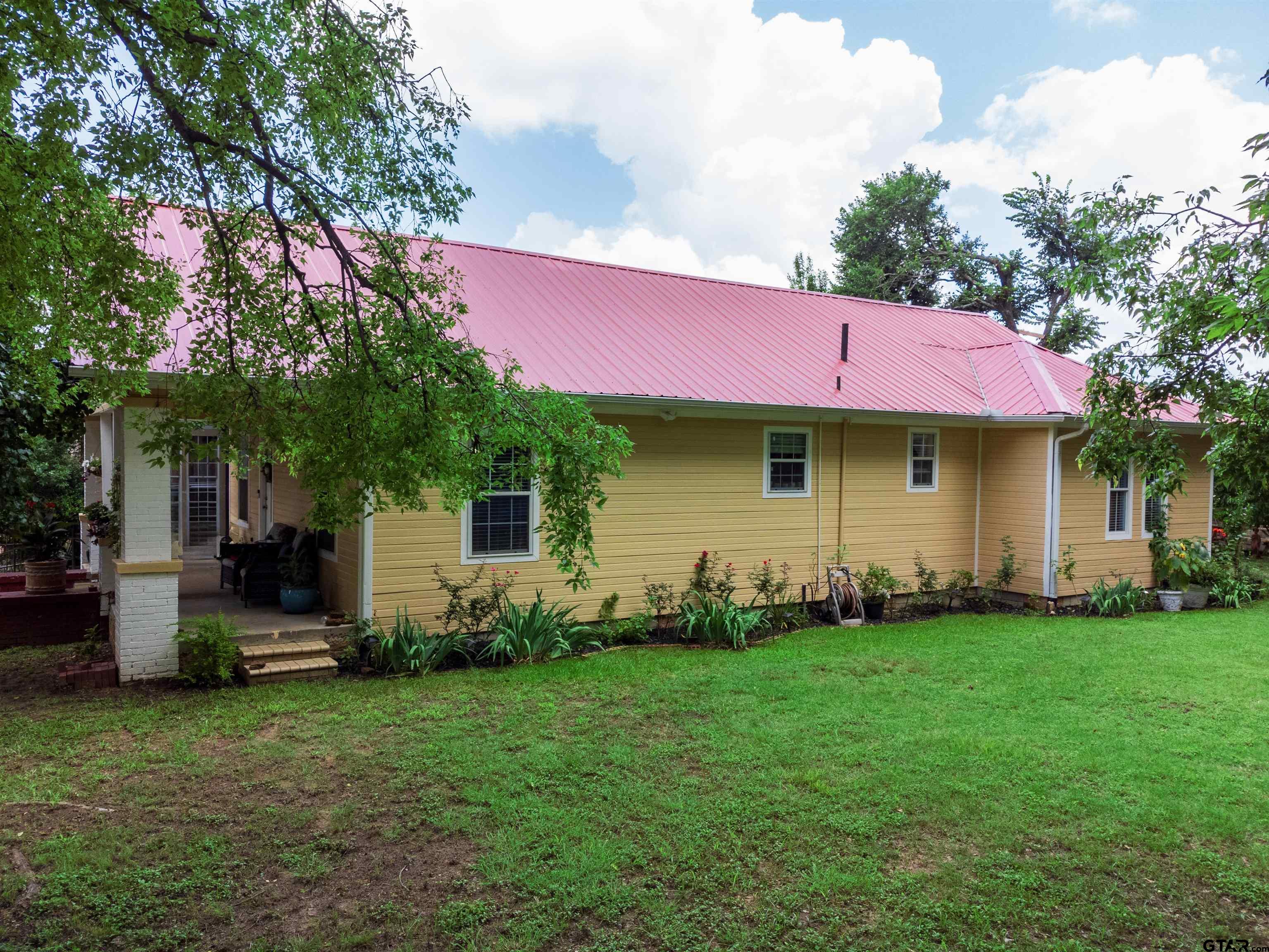 427 East Locust Street Tyler, TX 75702 - Photo 2 of 42 a front view of a house with a garden