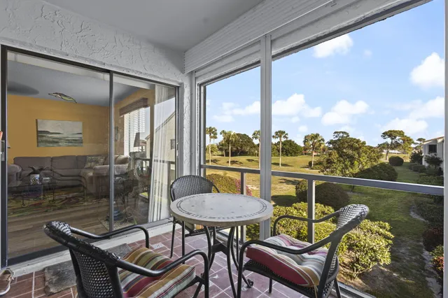 a view of a balcony with chairs