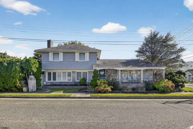a front view of a residential apartment building with a yard