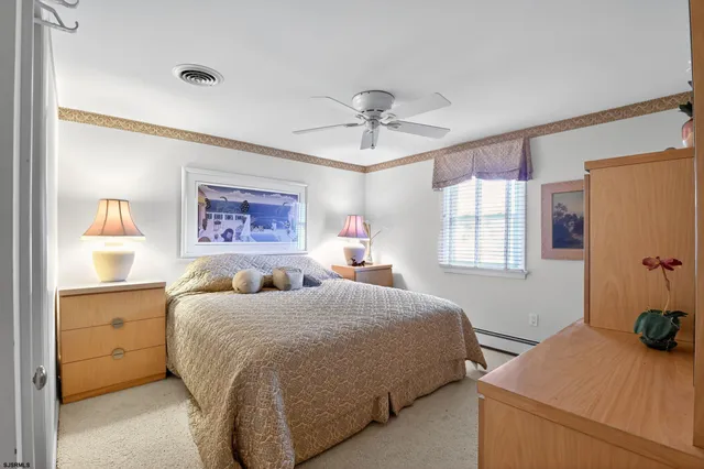 a living room with furniture and a dining table with wooden floor