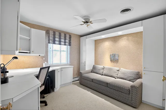 a view of a dining room with furniture and a potted plant